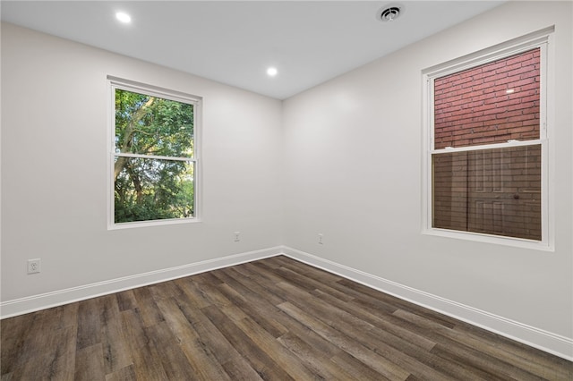 spare room with dark wood-type flooring