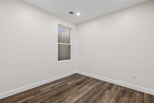 unfurnished room with dark wood-type flooring