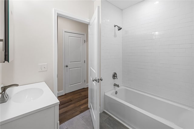 bathroom with tiled shower / bath, vanity, and tile patterned floors