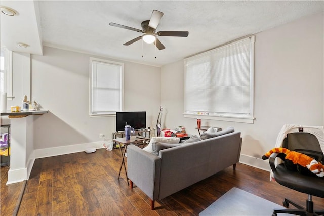 living room with ceiling fan and dark hardwood / wood-style floors