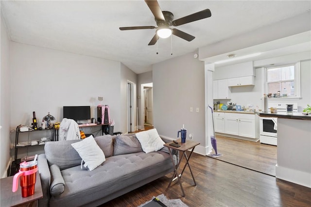 living room with ceiling fan and dark hardwood / wood-style floors