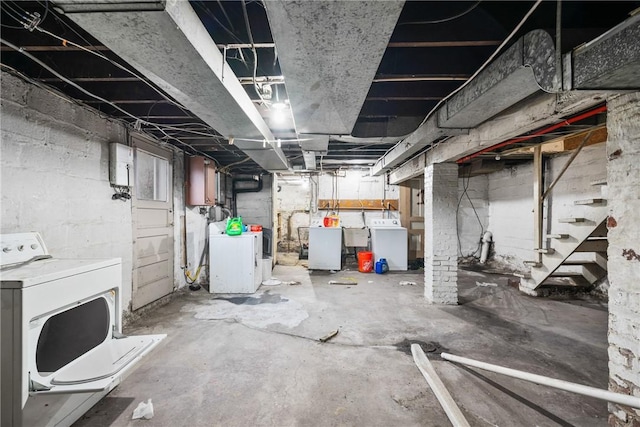 basement with washer and clothes dryer and sink