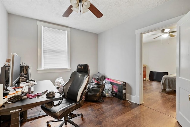 home office with ceiling fan, wood-type flooring, and a textured ceiling