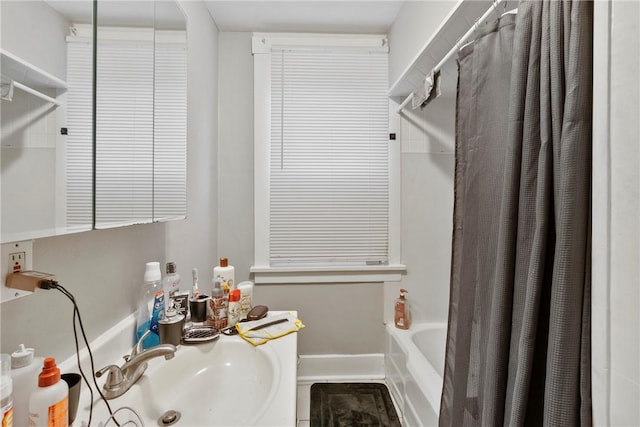 bathroom with sink and shower / tub combo with curtain