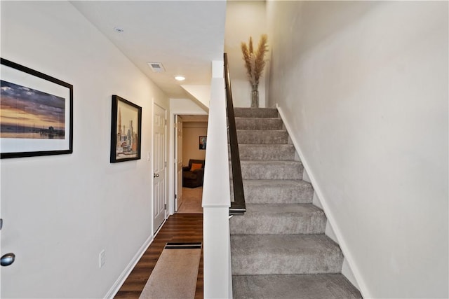 stairs featuring wood-type flooring