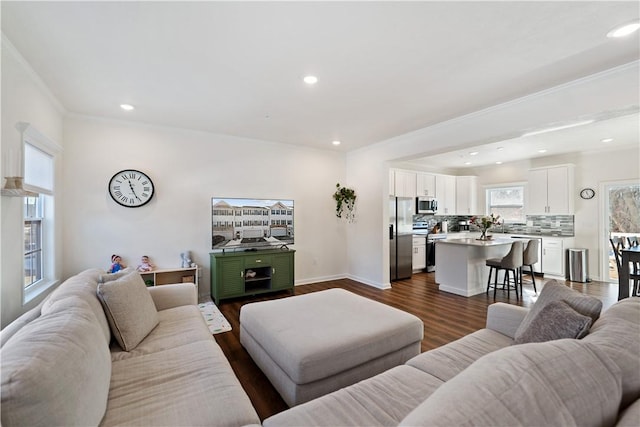 living room featuring dark wood-type flooring and ornamental molding