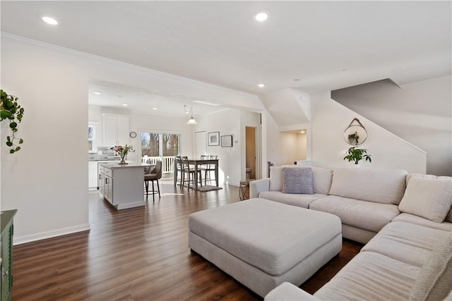 living room with crown molding and dark hardwood / wood-style flooring