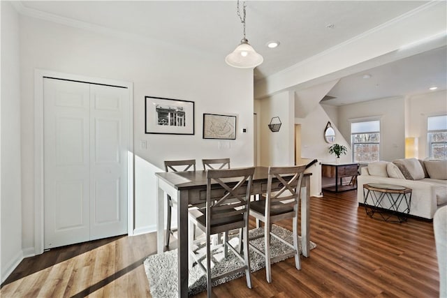 dining area with crown molding and dark hardwood / wood-style floors