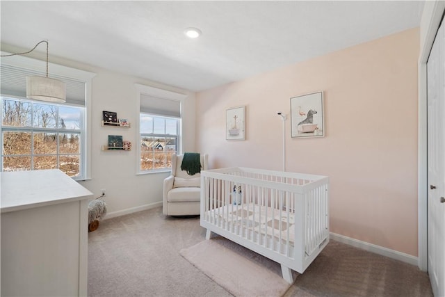 bedroom featuring carpet and a crib