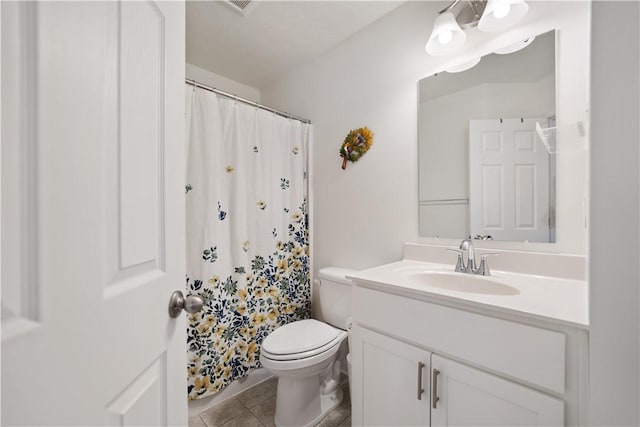 bathroom featuring tile patterned floors, toilet, and vanity