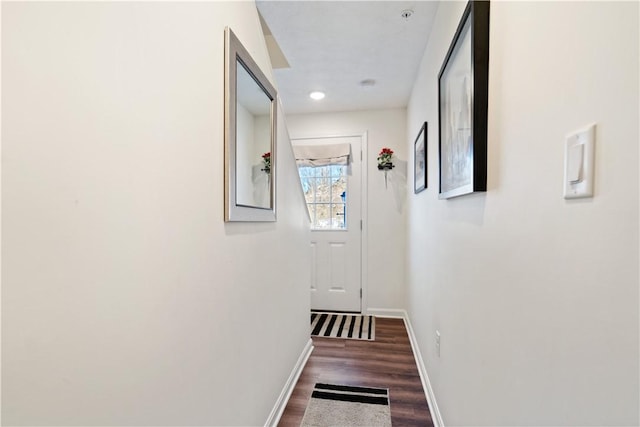 corridor with dark hardwood / wood-style flooring