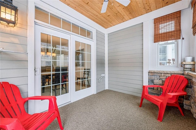 sunroom / solarium featuring wood ceiling and ceiling fan