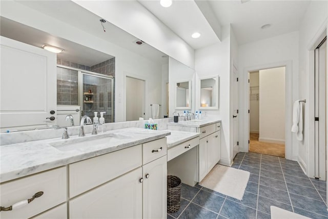 bathroom featuring tile patterned floors, vanity, and a shower with door