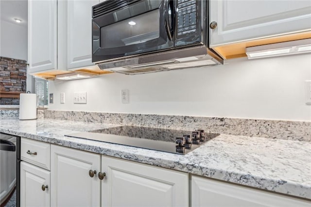 kitchen with white cabinetry and black appliances