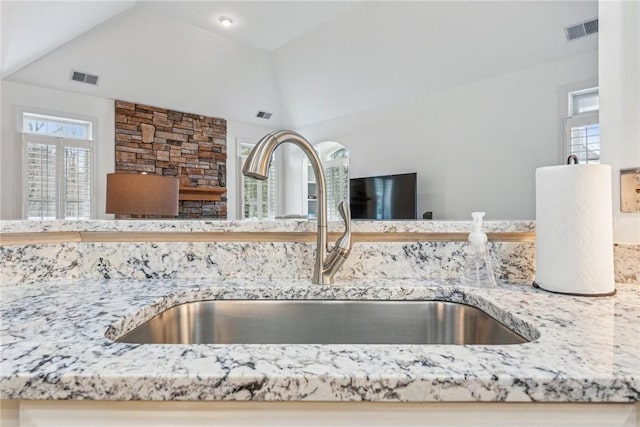 interior details with sink and light stone countertops