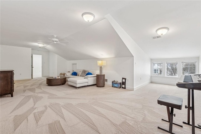 interior space with lofted ceiling, light colored carpet, and ceiling fan