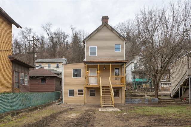 back of property with a porch