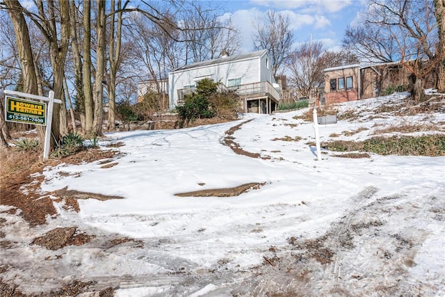 yard layered in snow with a deck