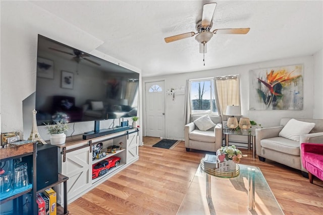 living room with ceiling fan and light hardwood / wood-style floors