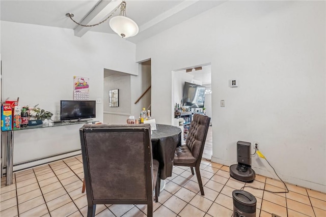 dining room with light tile patterned floors, beam ceiling, and baseboard heating