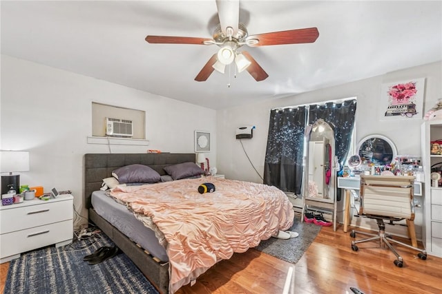 bedroom with hardwood / wood-style floors and ceiling fan