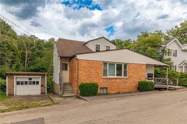 view of front of house with a garage and an outdoor structure