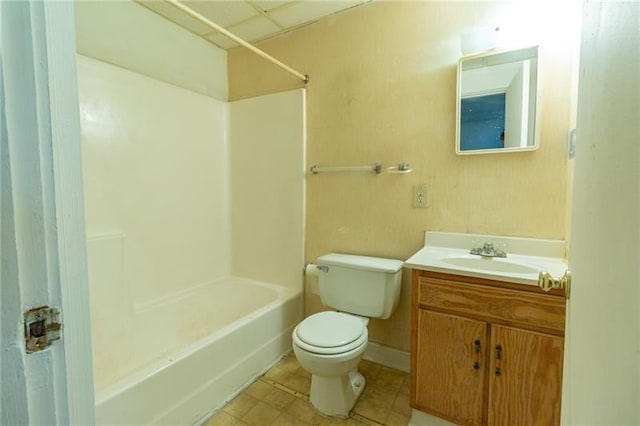 bathroom with vanity, a drop ceiling, and toilet