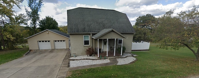 view of front facade featuring a garage, an outdoor structure, and a front lawn