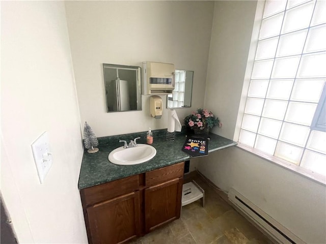 bathroom featuring vanity and baseboard heating