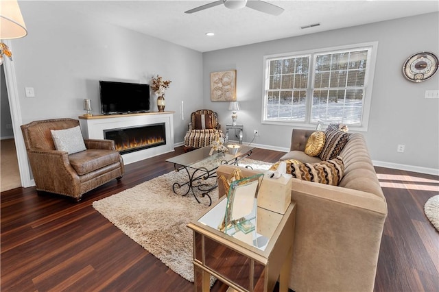 living room featuring dark hardwood / wood-style floors and ceiling fan