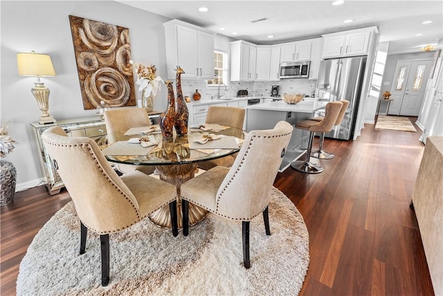 dining space featuring sink and dark hardwood / wood-style floors