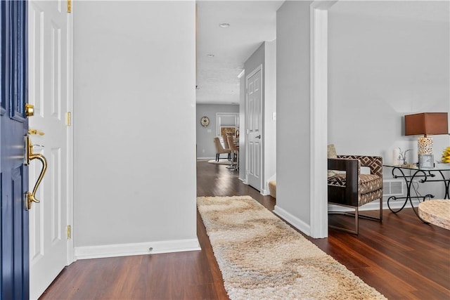 foyer entrance with dark hardwood / wood-style floors