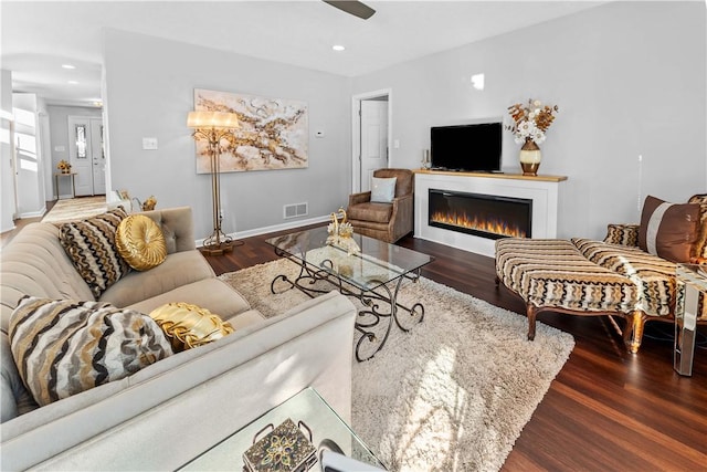 living room featuring dark hardwood / wood-style floors and ceiling fan