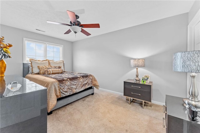 bedroom featuring light carpet and ceiling fan