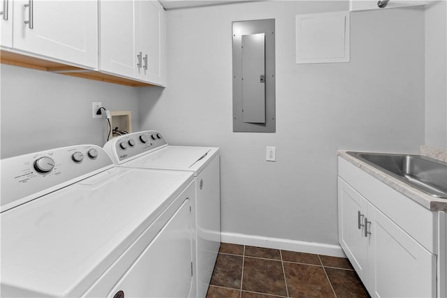 washroom with sink, cabinets, separate washer and dryer, electric panel, and dark tile patterned floors