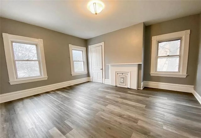 unfurnished living room featuring dark wood-type flooring