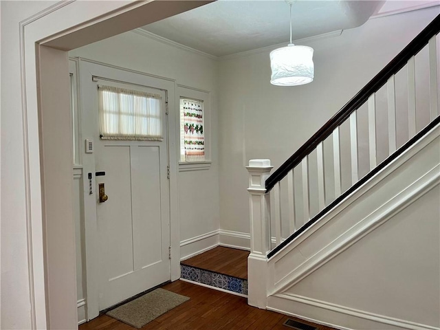 foyer entrance featuring crown molding and dark hardwood / wood-style floors