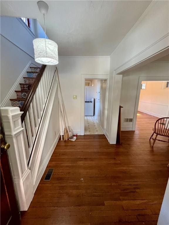 corridor featuring stairs, visible vents, and dark wood finished floors