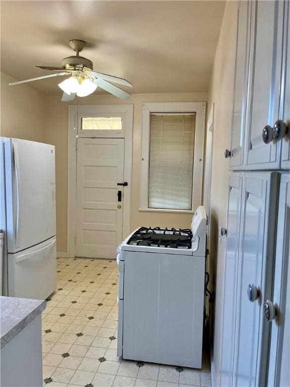 kitchen featuring white cabinets, white appliances, and ceiling fan