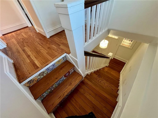 stairs featuring hardwood / wood-style floors