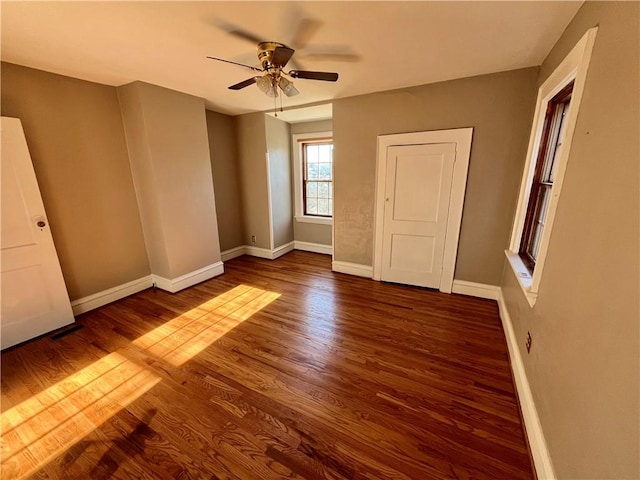 unfurnished room featuring dark hardwood / wood-style flooring and ceiling fan