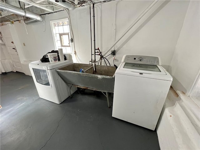 laundry area featuring laundry area, a sink, and washing machine and clothes dryer