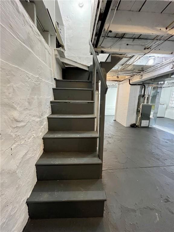 staircase featuring concrete flooring