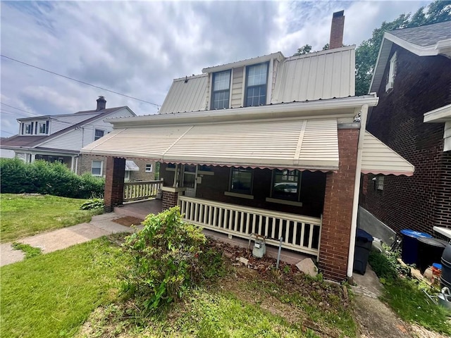520 Berwin Ave, Brookline, PA 15226 - view of front facade with a porch, a metal roof, a front lawn, and brick siding