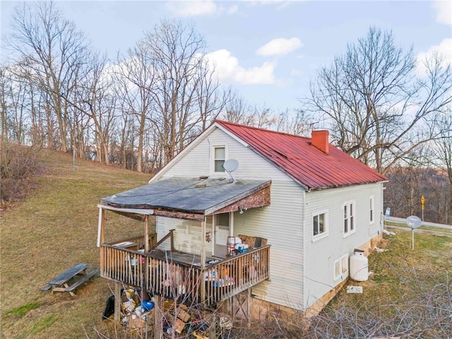 exterior space with a wooden deck and a lawn