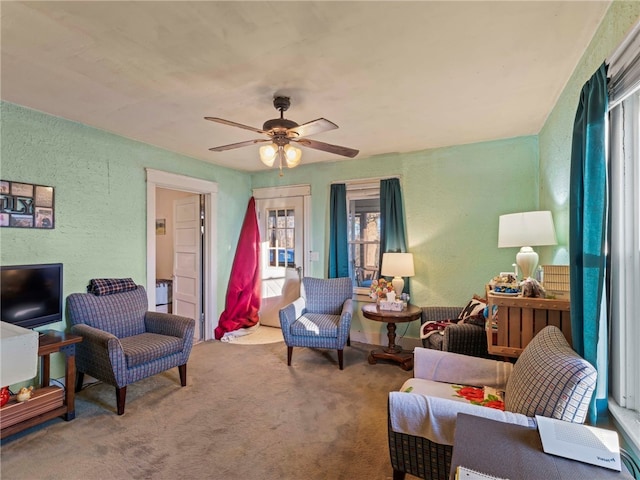 living room with ceiling fan and carpet flooring