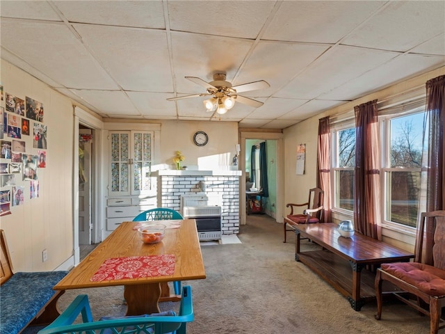 interior space with carpet, a paneled ceiling, and ceiling fan