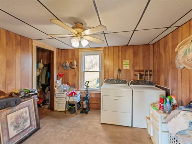 washroom featuring ceiling fan, washer and dryer, light carpet, and wooden walls