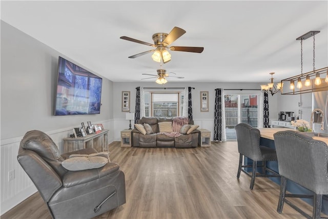 living room with hardwood / wood-style flooring and an inviting chandelier