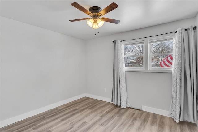 spare room with light hardwood / wood-style flooring and ceiling fan